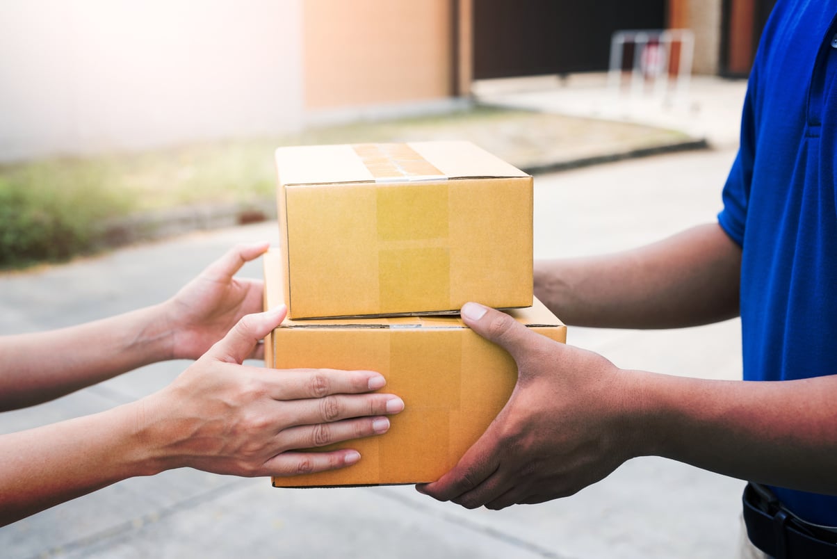 Women Hands Receiving Package from Delivery Man.